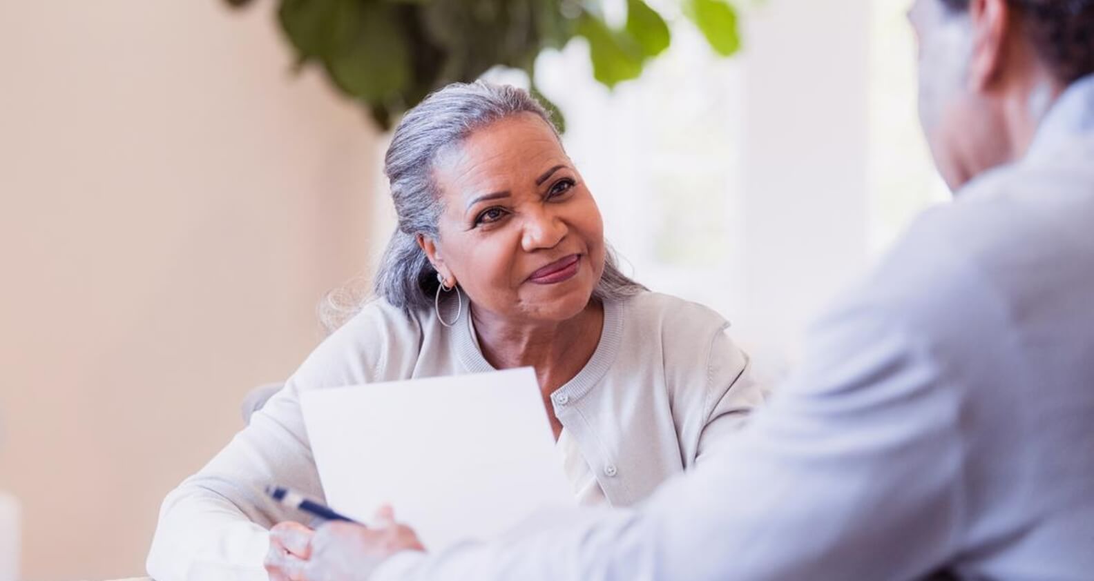 Woman sitting at table with paper