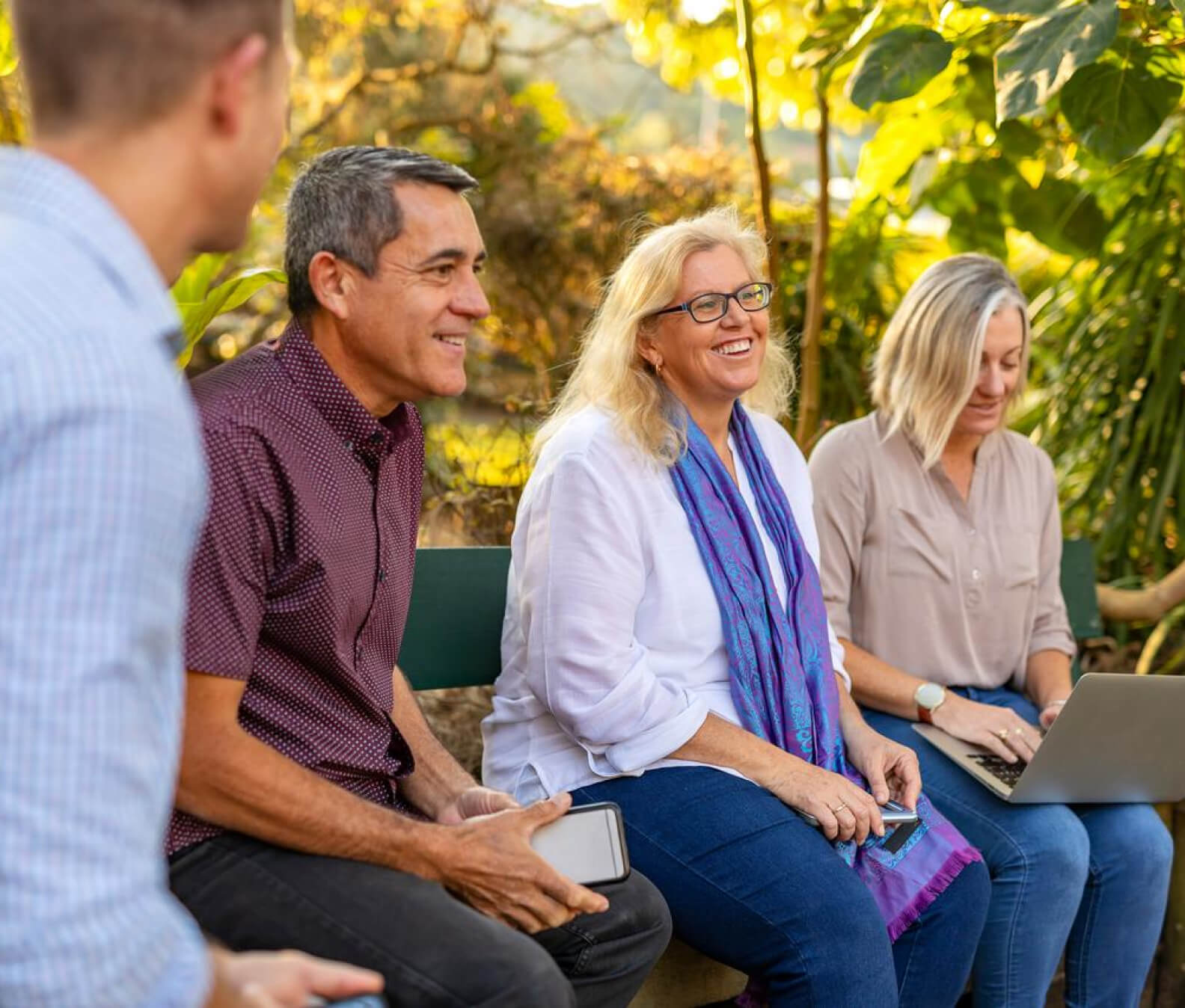 Group of people sitting in a garden