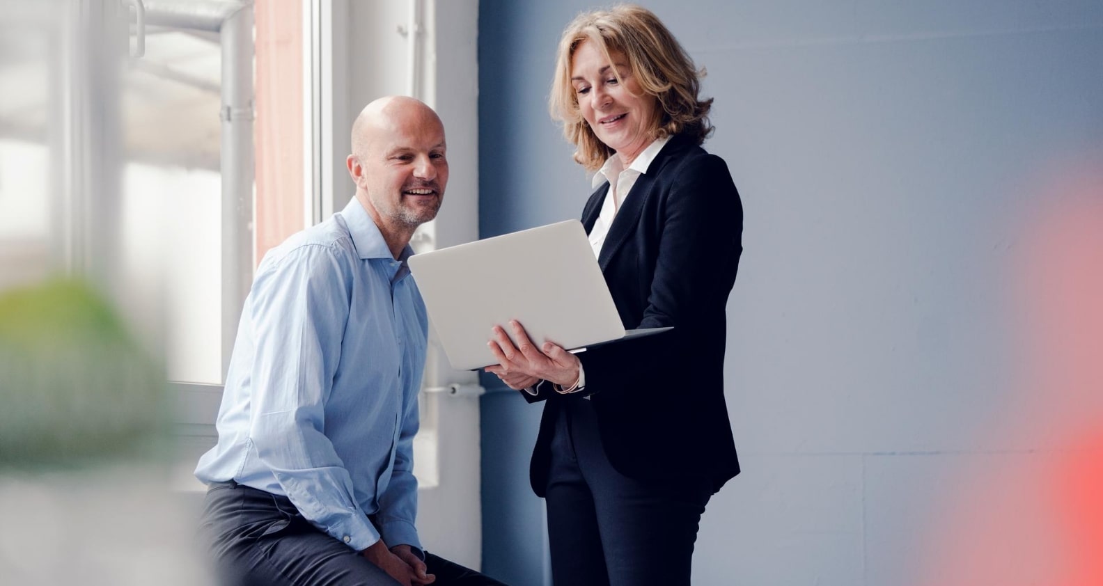 Corporate people looking at laptop