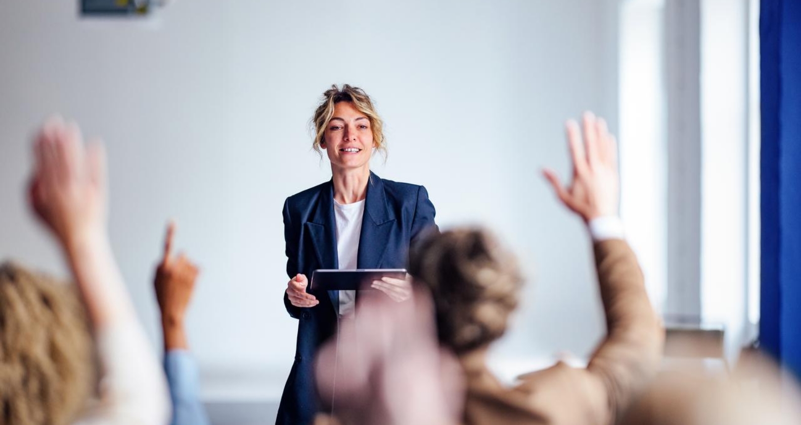 Woman in classroom asking questions