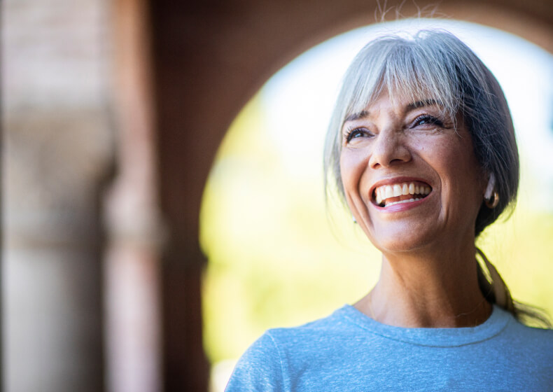 Woman smiling under bridge